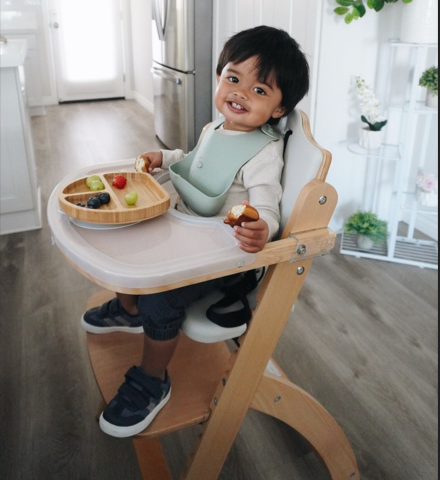 Child smiling in high chair