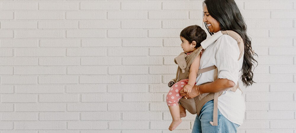 Mom using the top baby carrier