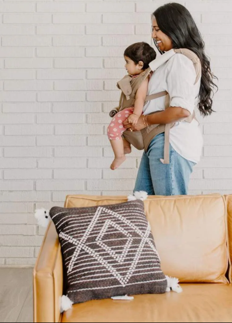 Mom using the top baby carrier