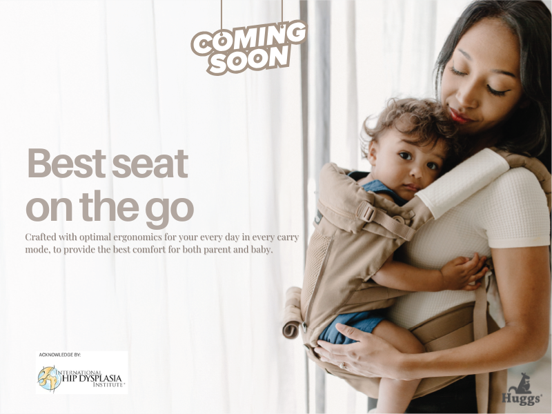 Huggs baby carrier in a neutral colour shown with its ergonomic straps and structured support.